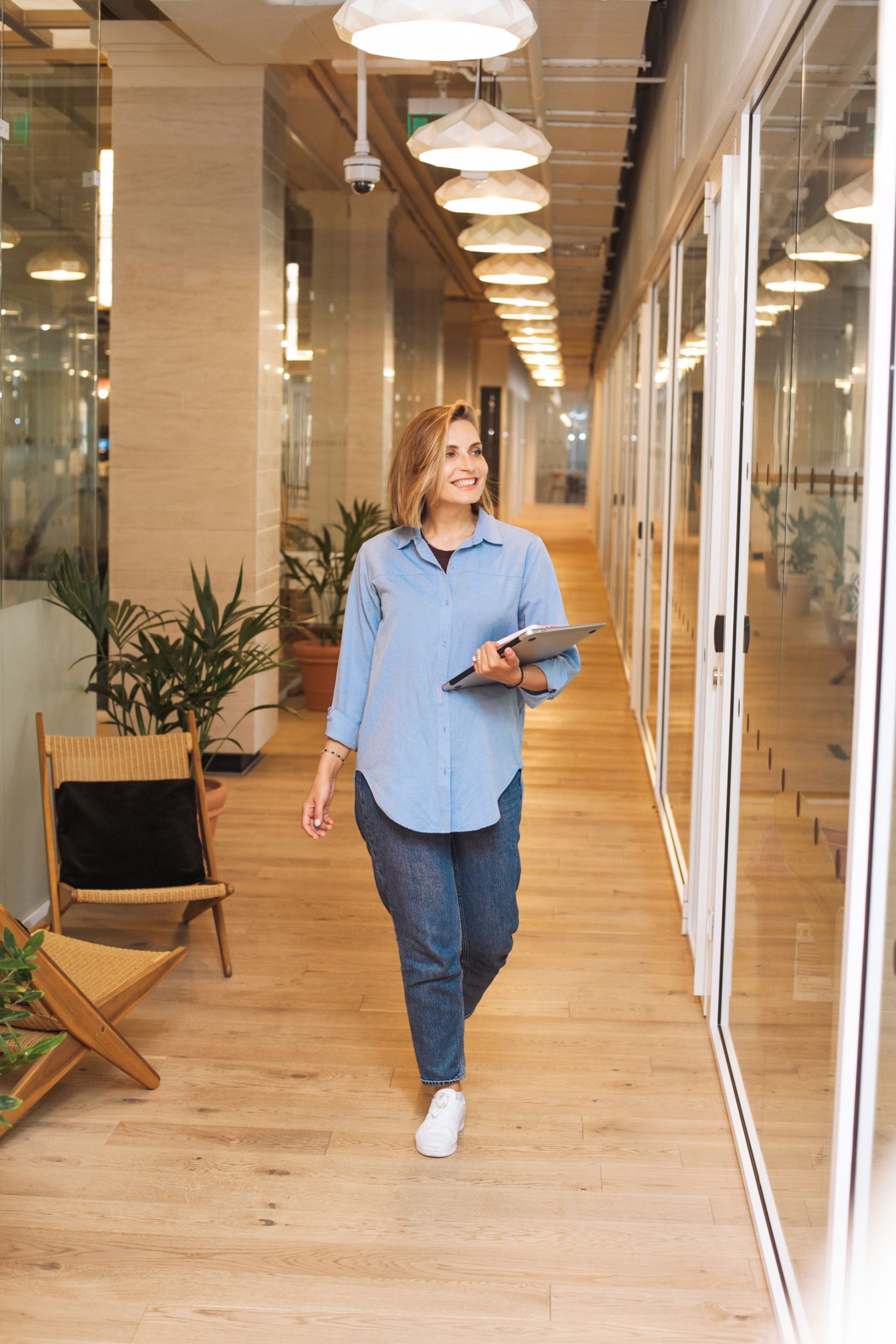 Female English speaker employee walking down the hall