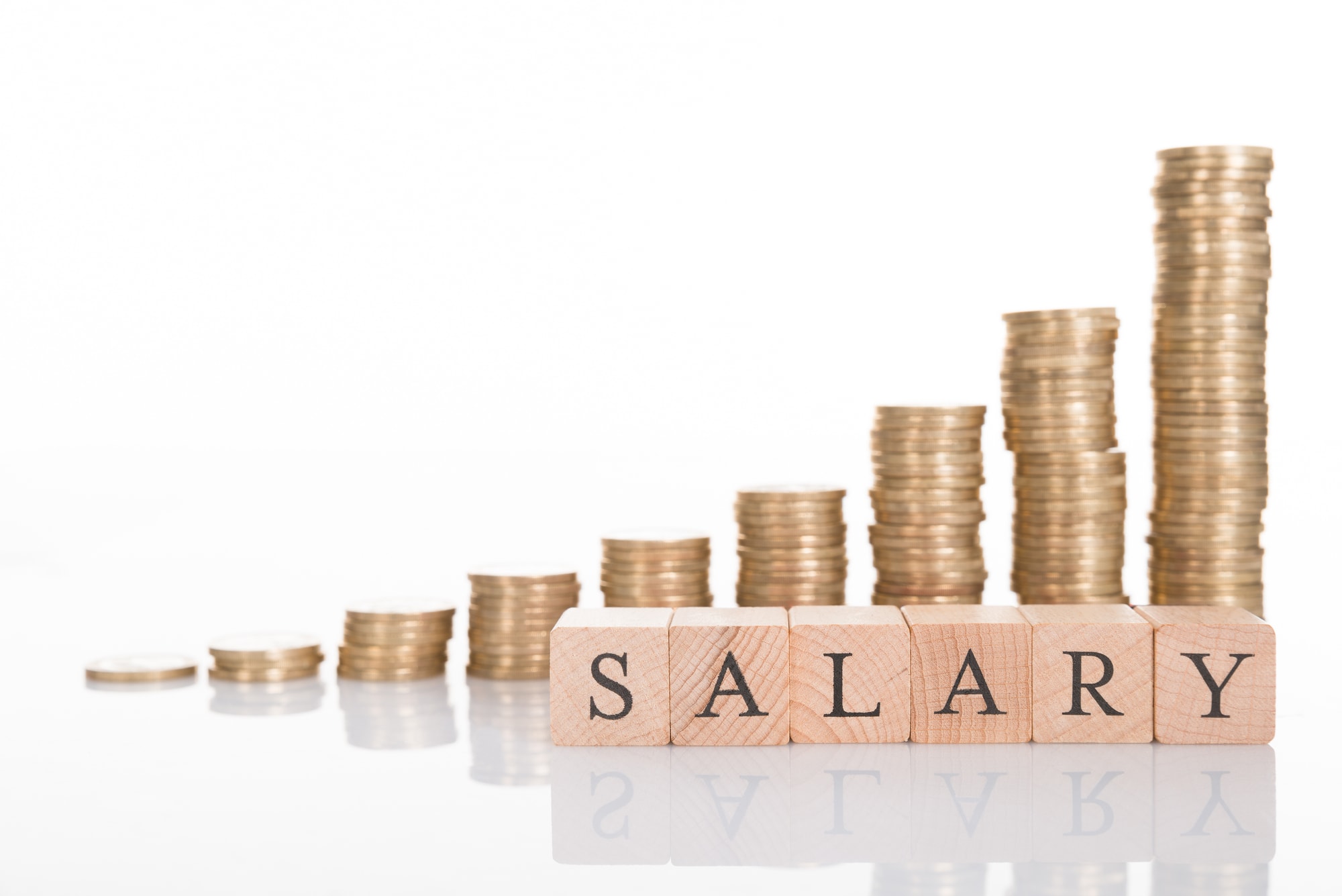 coin stacks increasing in size with letter blocks spelling salary